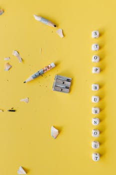 Flat lay of pencil, shavings, and message to stop burnout on yellow background.